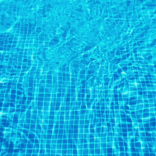 ripples of water in a pool finished with blue mosaic tile