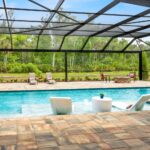 built in pool with wading deck and screen enclosure