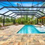 built in pool with wading deck and screen enclosure