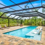 built in pool with wading deck and screen enclosure
