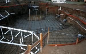 plumbing and electrical components installed in framework for a pool being constructed