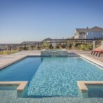 pool with wading step and raised hottub at a coastal property near the ocean